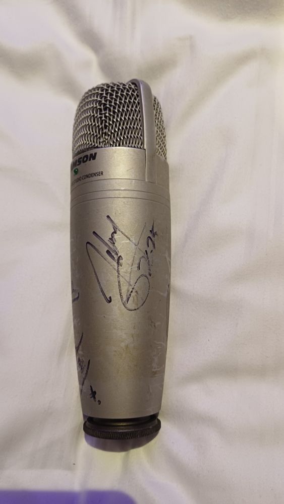 A Samsung microphone with Johnny Gioeli' signature on it. 
