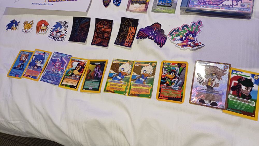 A few sonic, Tails knuckles and shadow stickers, and a few sonic con trading cards   