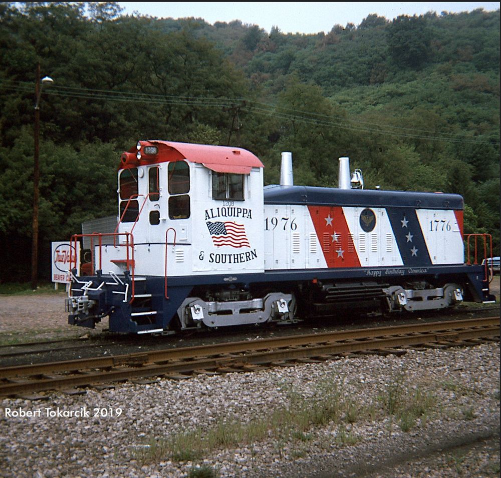 an emd sw1200 switcher diesel locomotive painted red white and blue