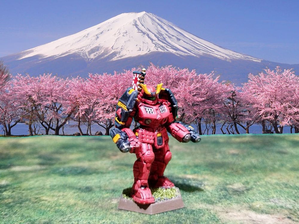 Una diorama con la miniatura de un Hatamoto-Chi en un campo. Tras de el se ven varios cerezos y más al fondo una gran montaña.

El Hatamoto-Chi es un mecha de silueta humanoide estilizado para tener la estética de una armadura samurái. Va armado con dos lanzadores de misiles de corto alcance en el pecho y un cañón de partículas en cada brazo.

Está pintado de rojo carmesí con acentos de color negro y amarillo. En su espalda porta un estandarte con la bandera imperial japonesa.