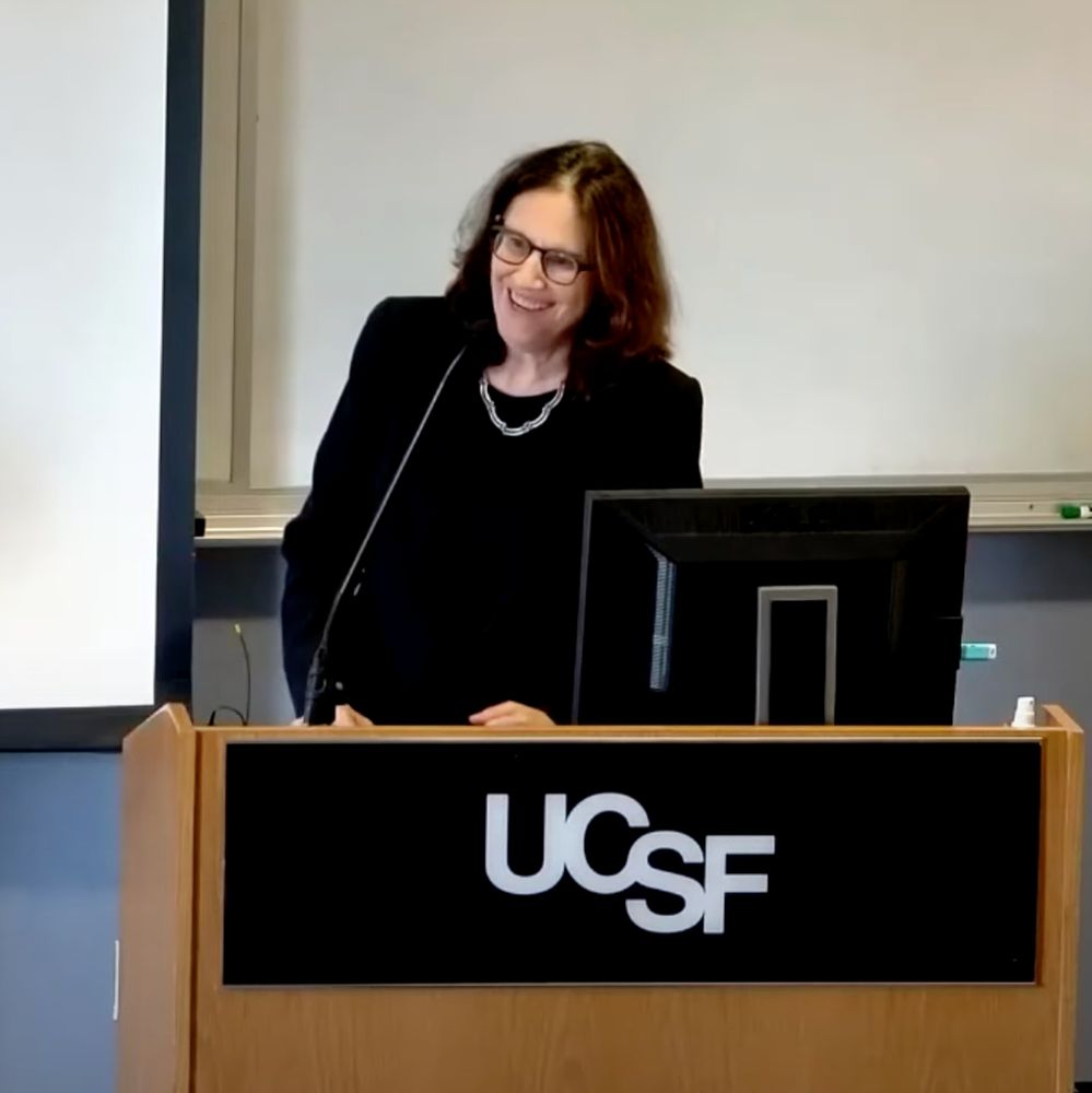 From behind a UCSF lecturn, Dr. Alicia Fernandez responds to an audience question.