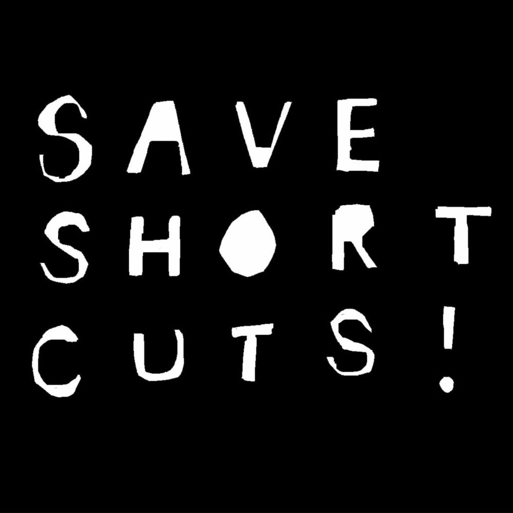 White cut out letters on a black background read ‘Save Short Cuts!’