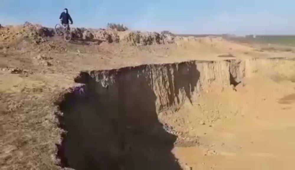 a person is riding a bike on top of a cliff in the desert .