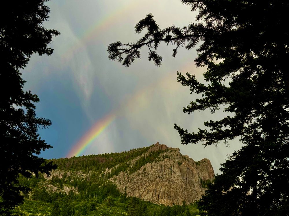 Two rainbows above a Colorado mountain
