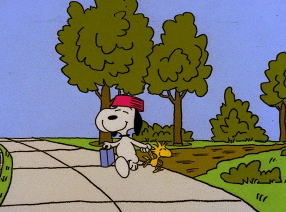 a cartoon of snoopy and woodstock walking down a street