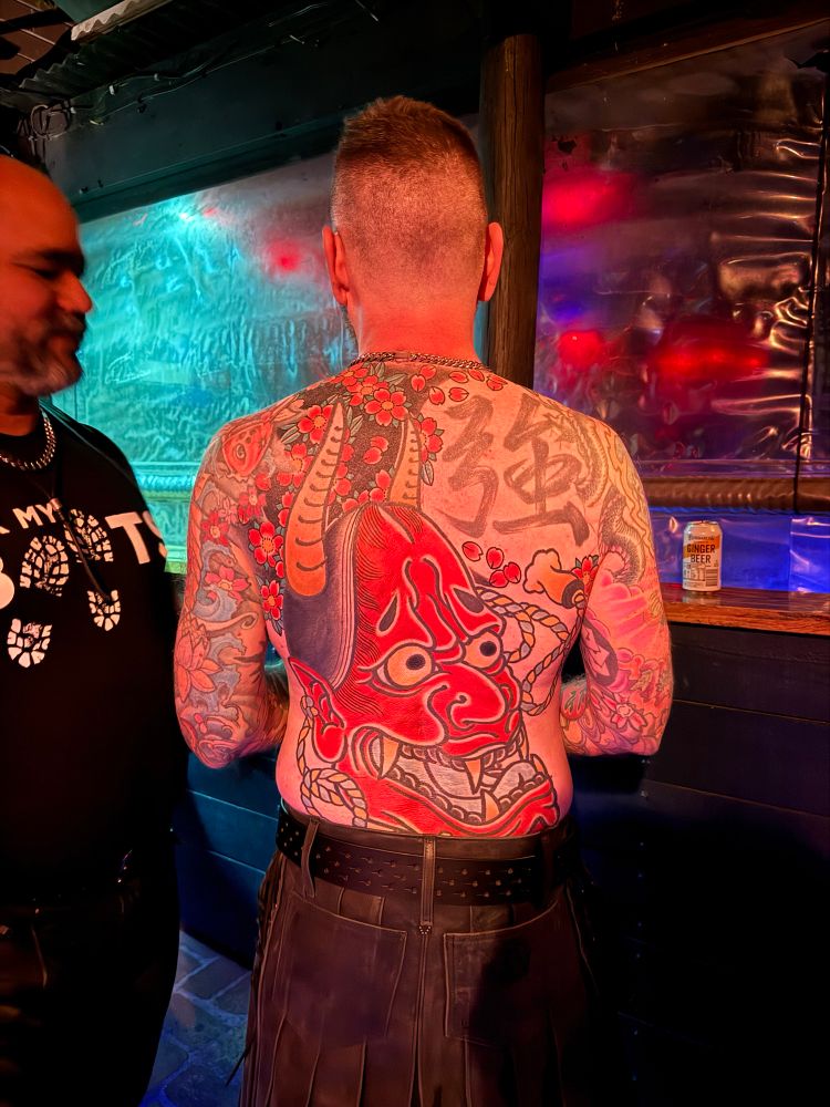 Man with large red oni tattoo on back. There is a Chinese character as well. 