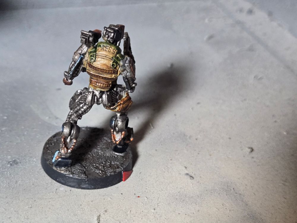 Back of the WarCor. Mostly gunmetal with a tan and brown press vest.