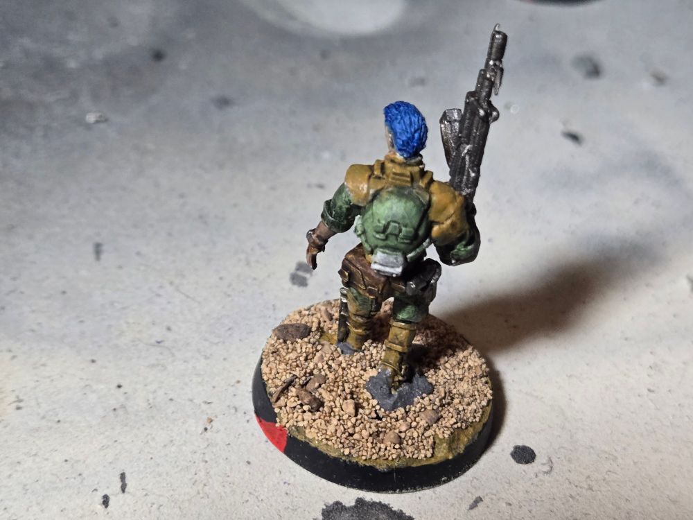 The back of the blue haired Daylami. He has brown pouches with a green and white backpack.
