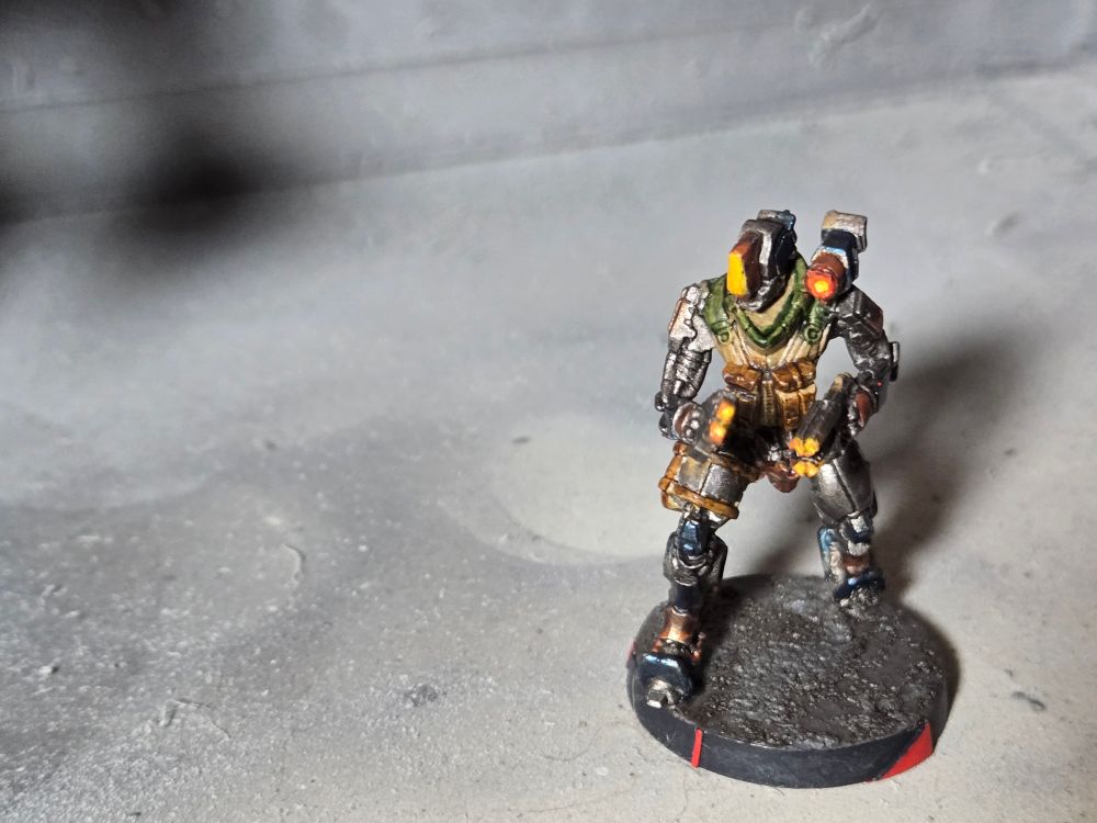Remote themed WarCor. Mostly gunmetal body with some brown leather pouches and yellow lights in the cameras and guns.