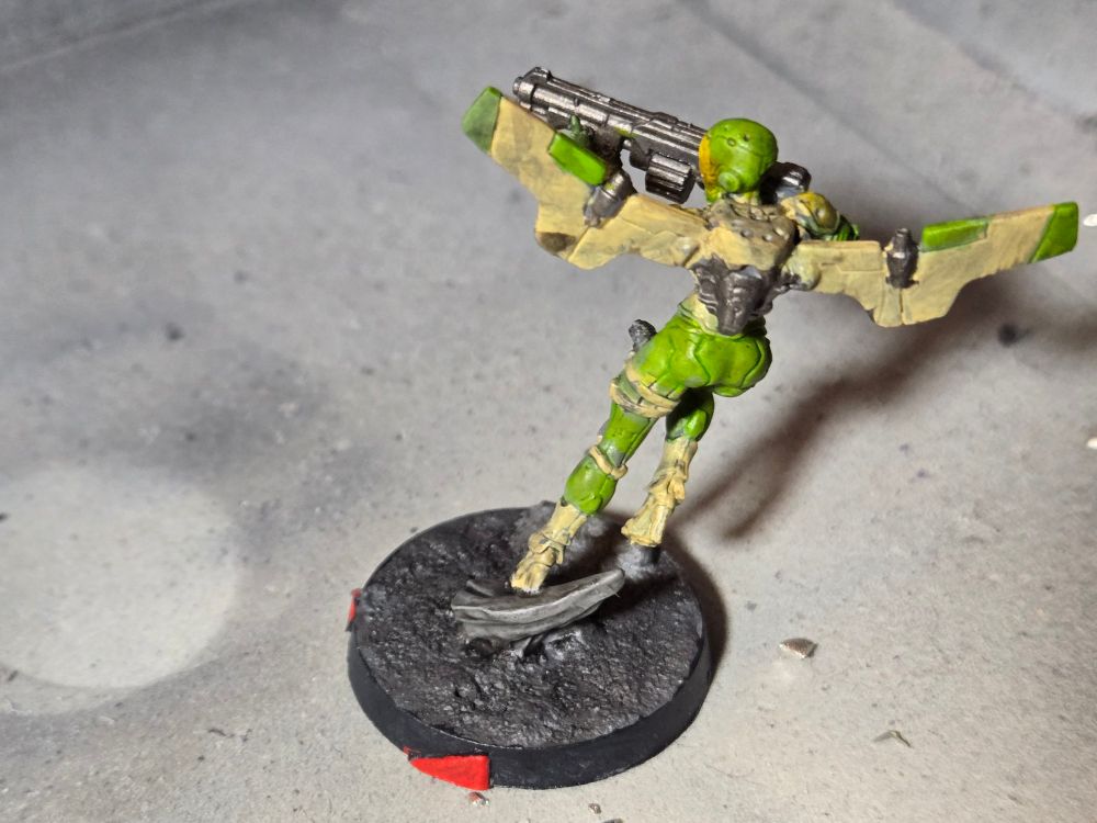 Back of the Ragik where you see more of its jetpack, mostly light sand in color with green and gunmetal accents.