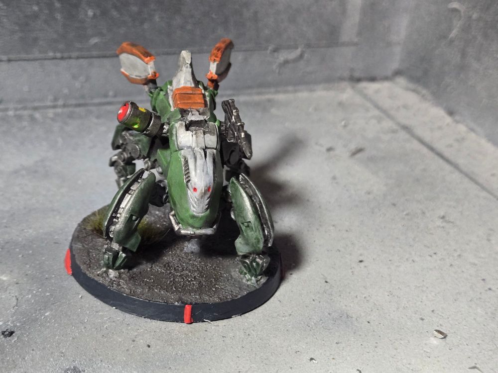 Rafiq remote. Green body and legs with white and orange top and fins. Gunmetal gun.