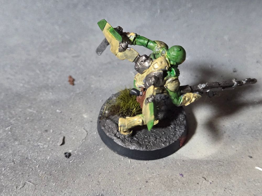 The back of the landing Ragik showing his jet pack, the same color as his armor, and a black handled pistol in a brown holster on his right leg.