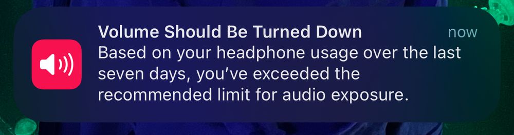 an apple notification saying “volume should be turned down. based on your headphone usage over the last seven days, you’ve exceeded the recommended limit for audio exposure.”