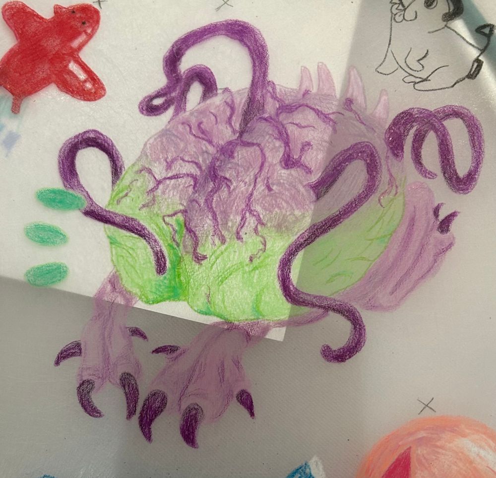 A pre-shrunk shrinky dink of Us from Baldurs Gate 3. Us is a neon green and purple brain creature called an intellect devourer