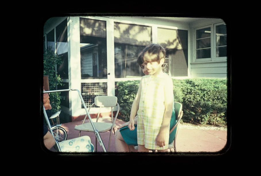 Me as a little kid eight years old. My mom cut my hair short and made me wear plaid shorts.