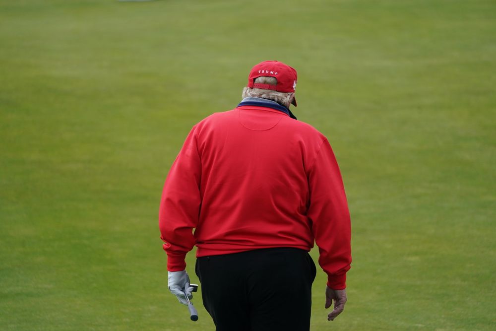 Rear view of Trump waddling on golf course