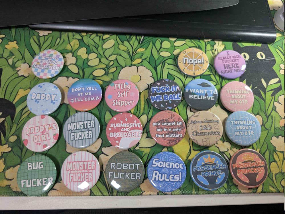 An array of pinback buttons wit primarily text designs.