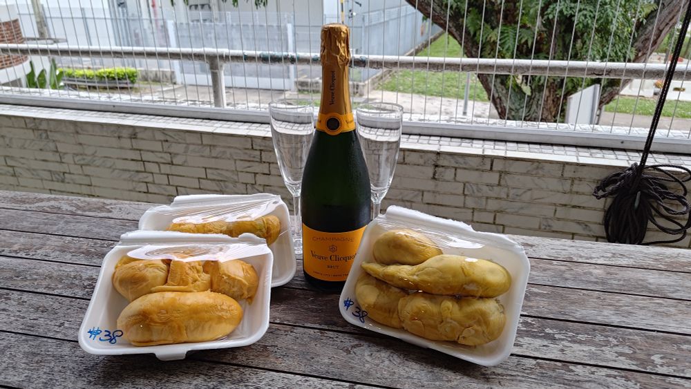 Three durian trays and a bottle of veuve cliquot champagne