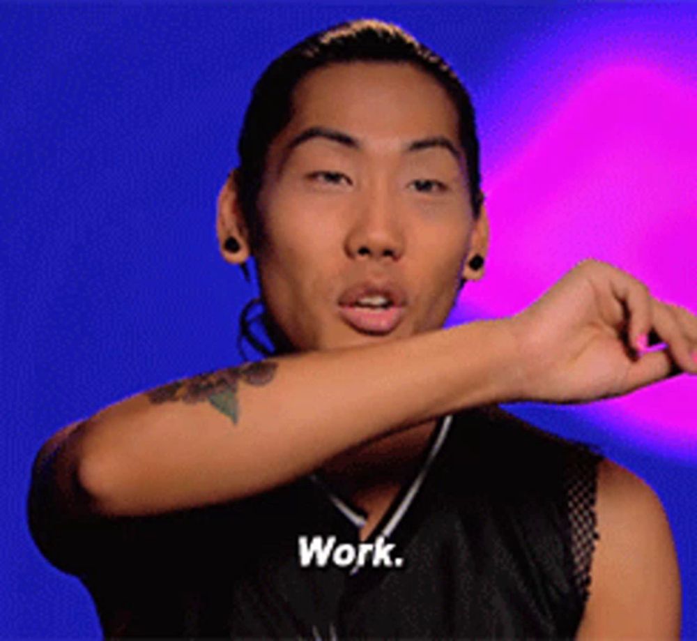 a man with a tattoo on his arm is wearing a shirt that says work