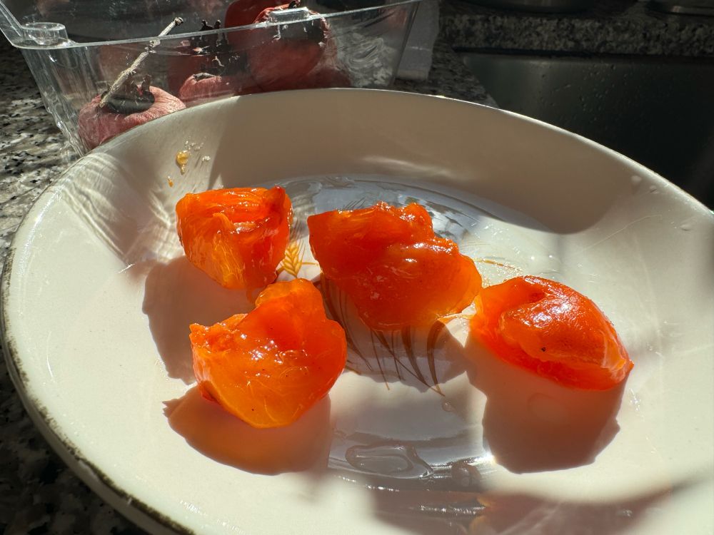Ripe persimmons peeled, cut into four, in a bowl. 