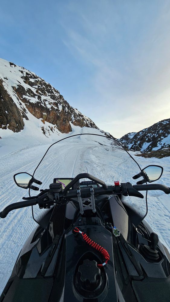 Driving a snowmobile up a hill