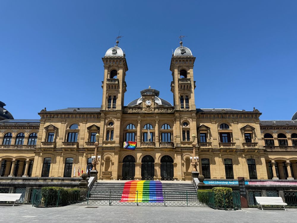 San Sebastián city hall with an intersex-inclusive pride flag hanging on the balcony and pride paint on the stairs