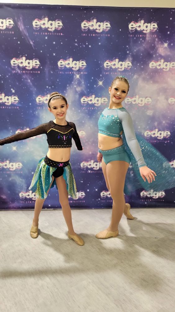 Children dressed in custom Anna and Elsa dance costumes.