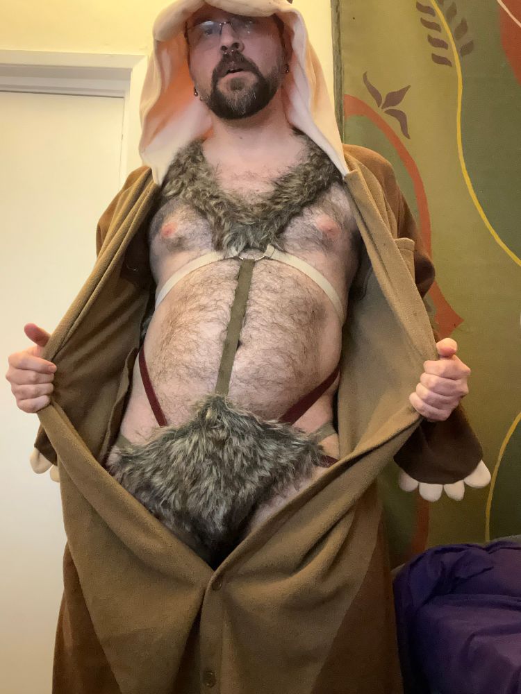 Me wearing an open otter onesie with a fur harness underneath