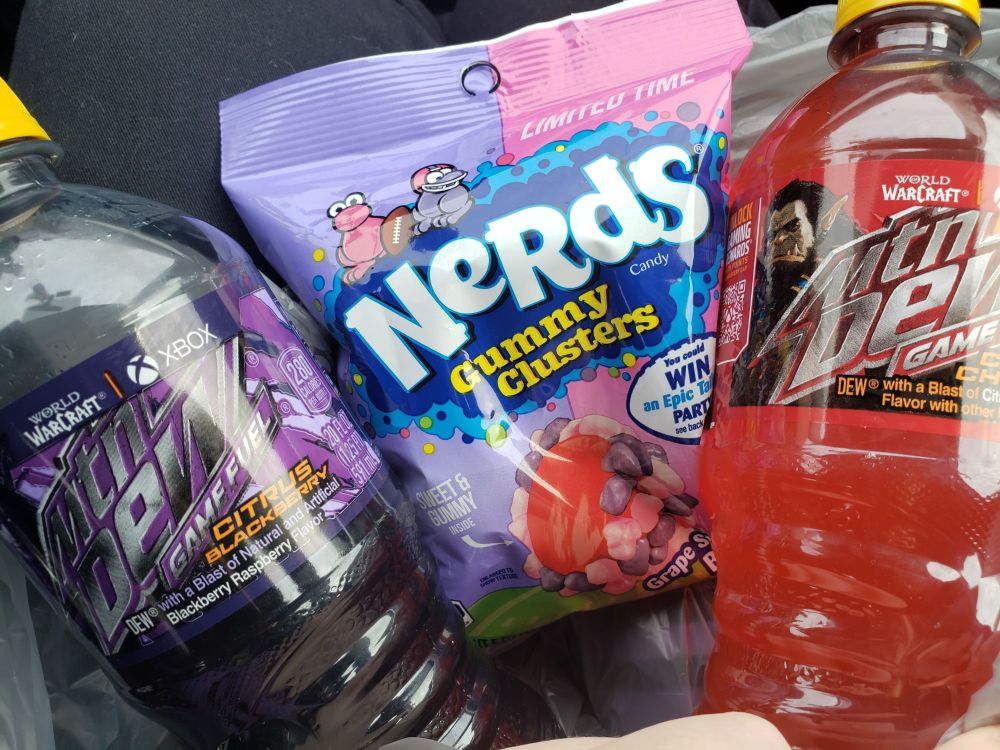 a photo of the two limited time mountain dew flavors and a packet of the grape strawberry nerds gummy clusters