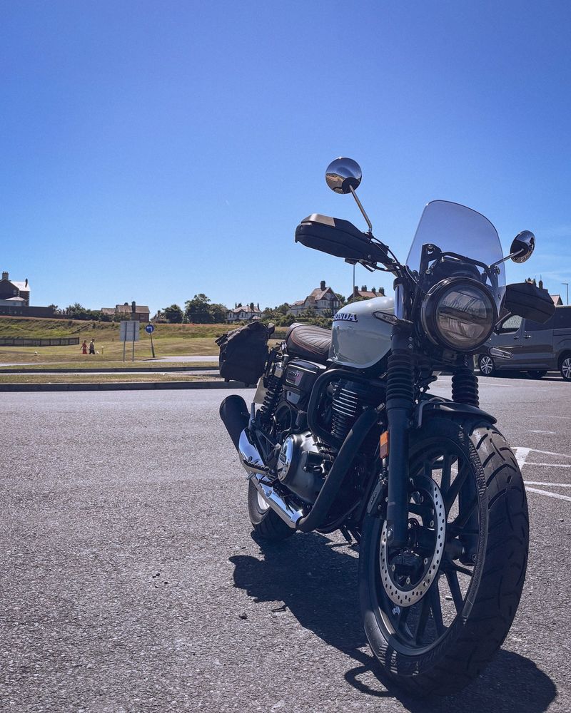 A picture of a blue Honda motorcycle on a sunny day.