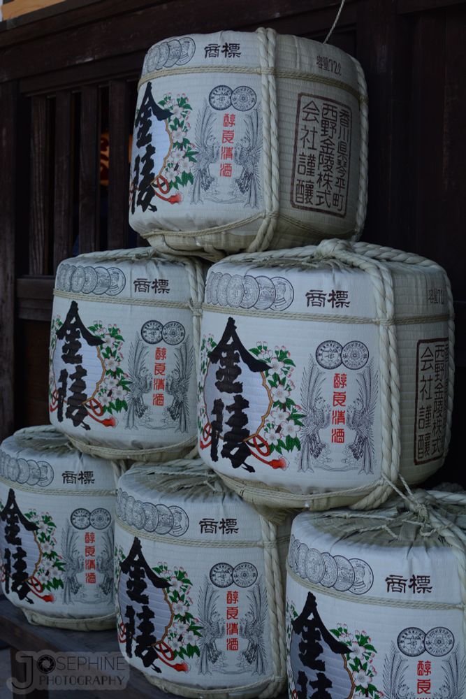 several knotted barrels of sake stacked on each other