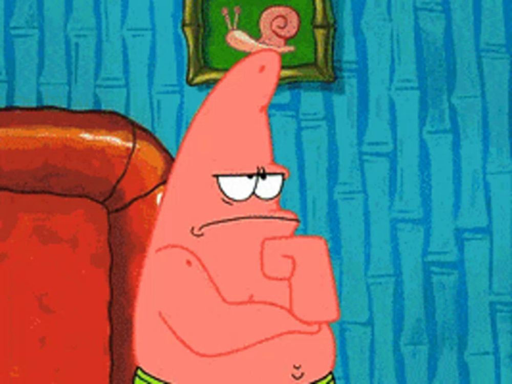 patrick star from spongebob squarepants is sitting on a couch with his hand on his chin