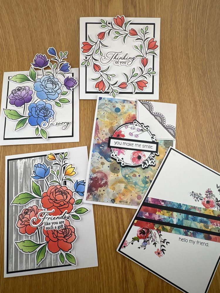 A picture of five handmade greeting cards featuring flower designs. 