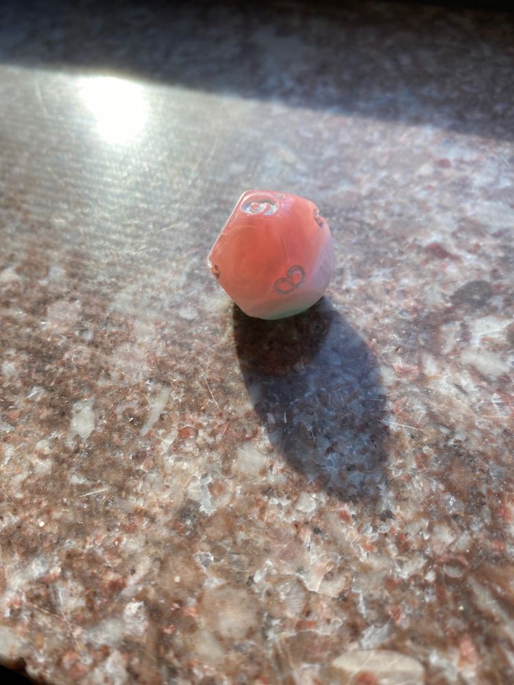 A d9 resting on a granite surface