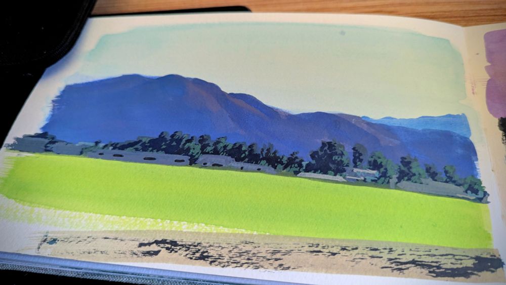 landscape painting of a green field in front of hazy mountains