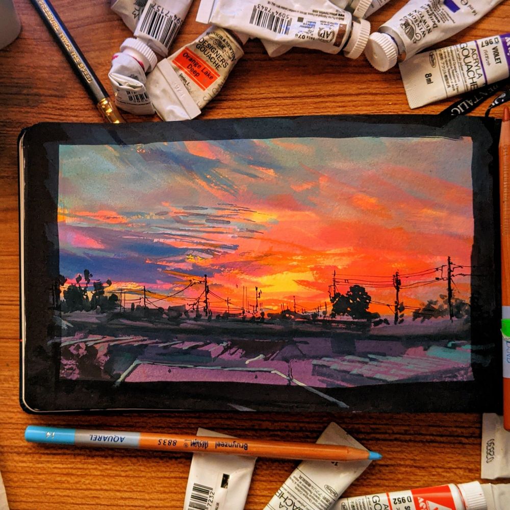 painting of a blazing sunset over city rooftops