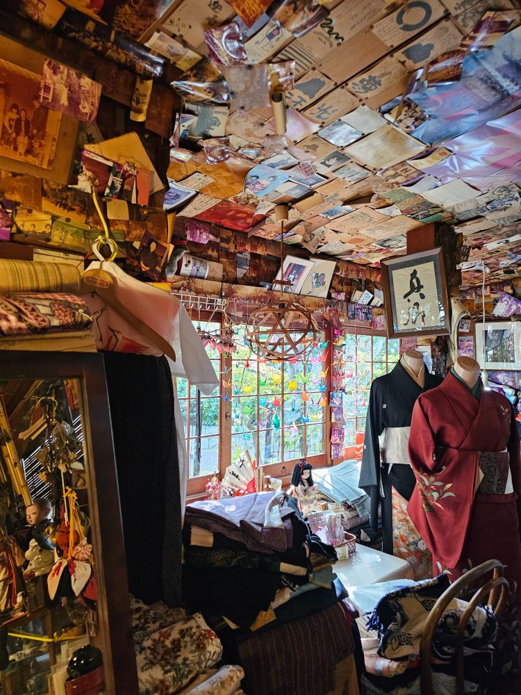 Tiny Kimono shop situated along the Philosopher's Path in Kyoto, Japan. Walls and shelves covered with knick-knacks, materials and patterns, drawings and paintings, photographs of produced kimonos and postcards from satisfied customers.