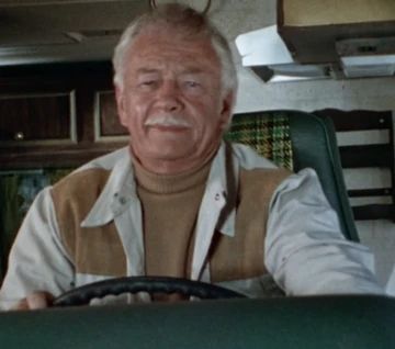 A mustache dude named Mentor, who drives Billy Batson around in his van 