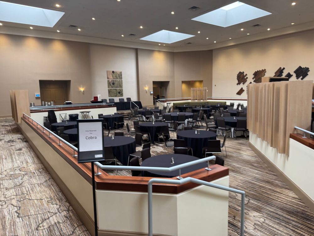 Tables inside a hotel lobby that is used for WoTCon