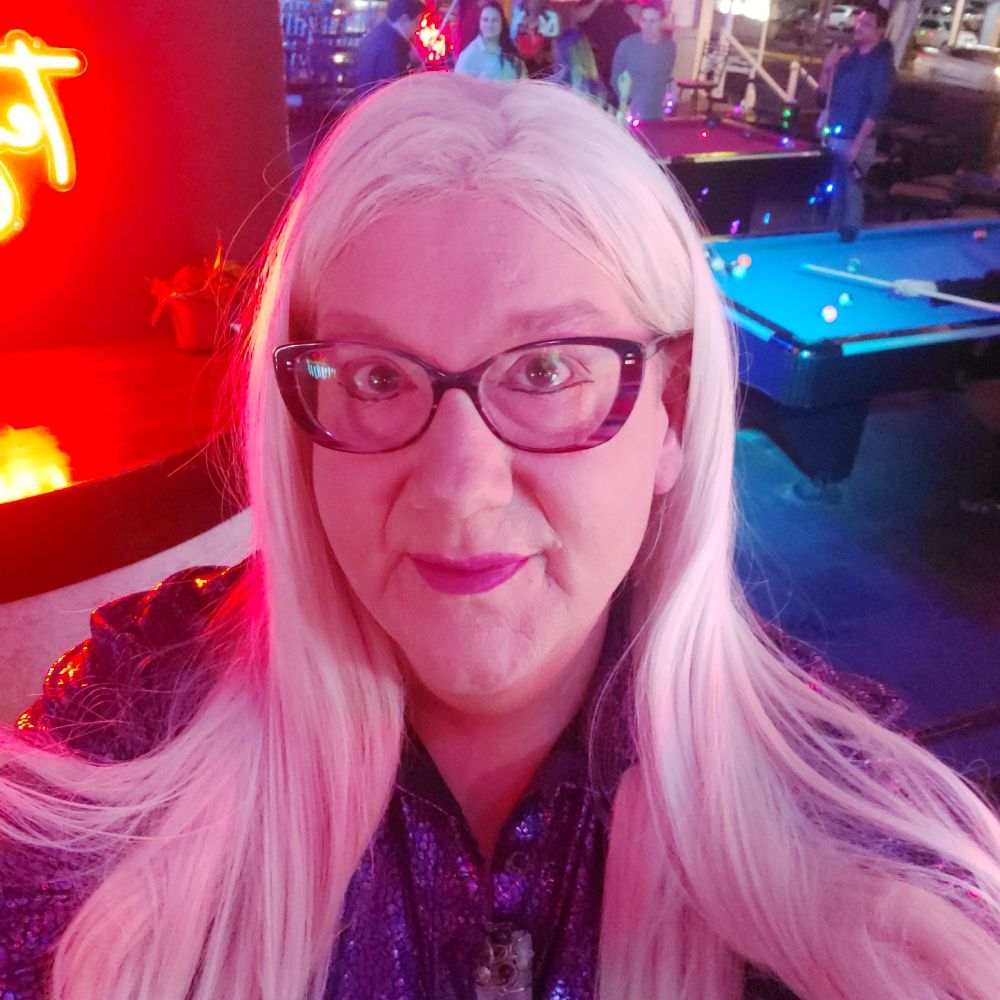 Blonde hair woman with glasses in a pool hall