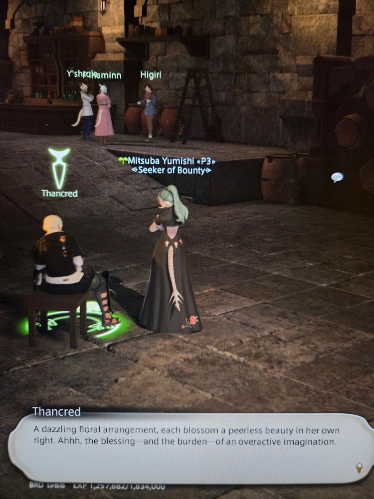 Thancred is sitting across the room from Y'shtola, F'lhaminn, and Higiri, three women who are having a conversation. He says "A dazzling floral arrangement, each blossom a peerless beauty in her own right. Ahhh, the blessing--and the burden--of an overactive imagination."