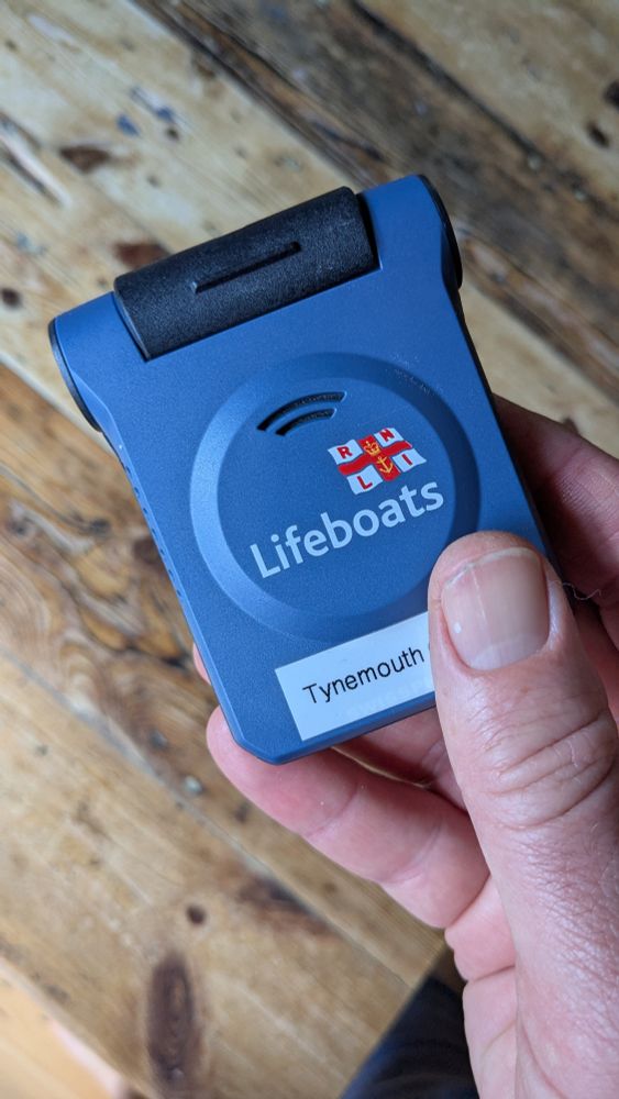 Close up of blue RNLI pager