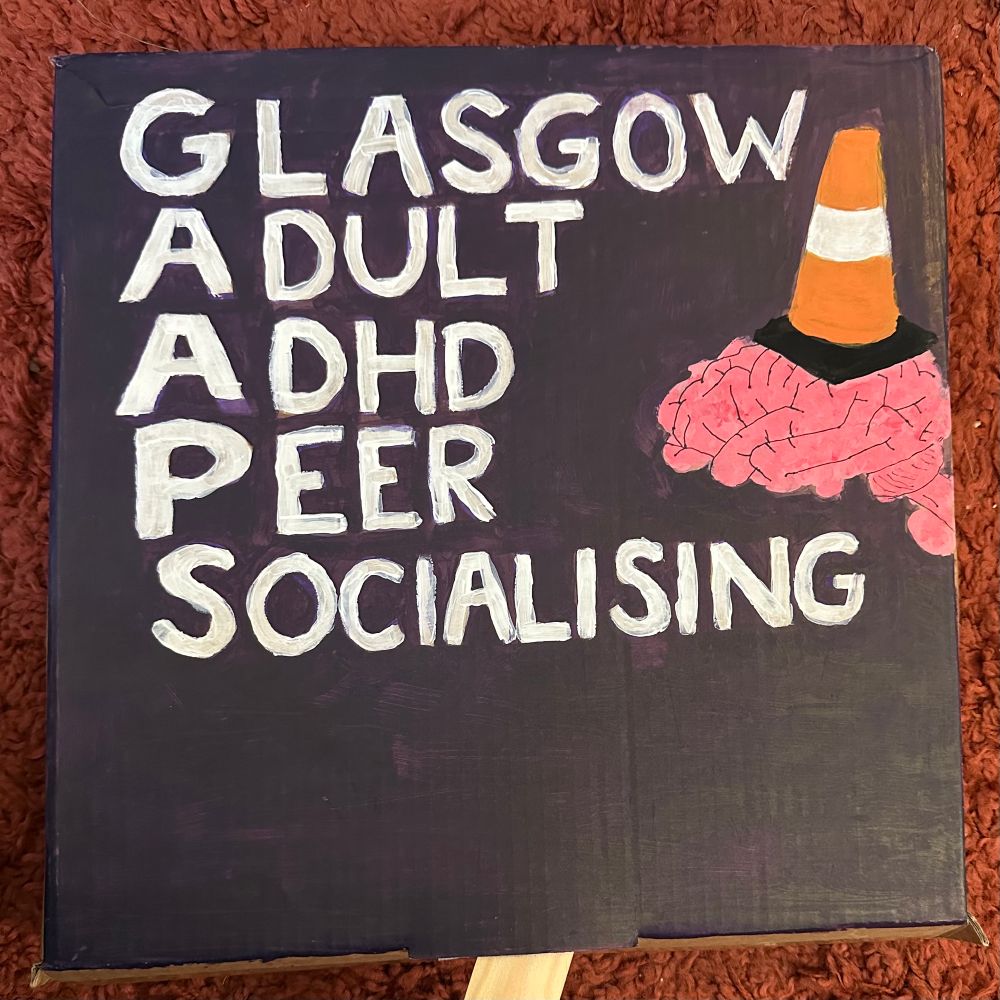 A painted sign with our name and logo - a brain with a traffic cone hat