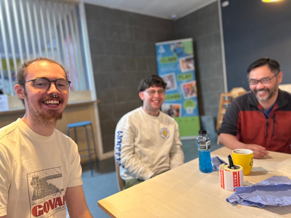 Three of our members sitting around a table laughing