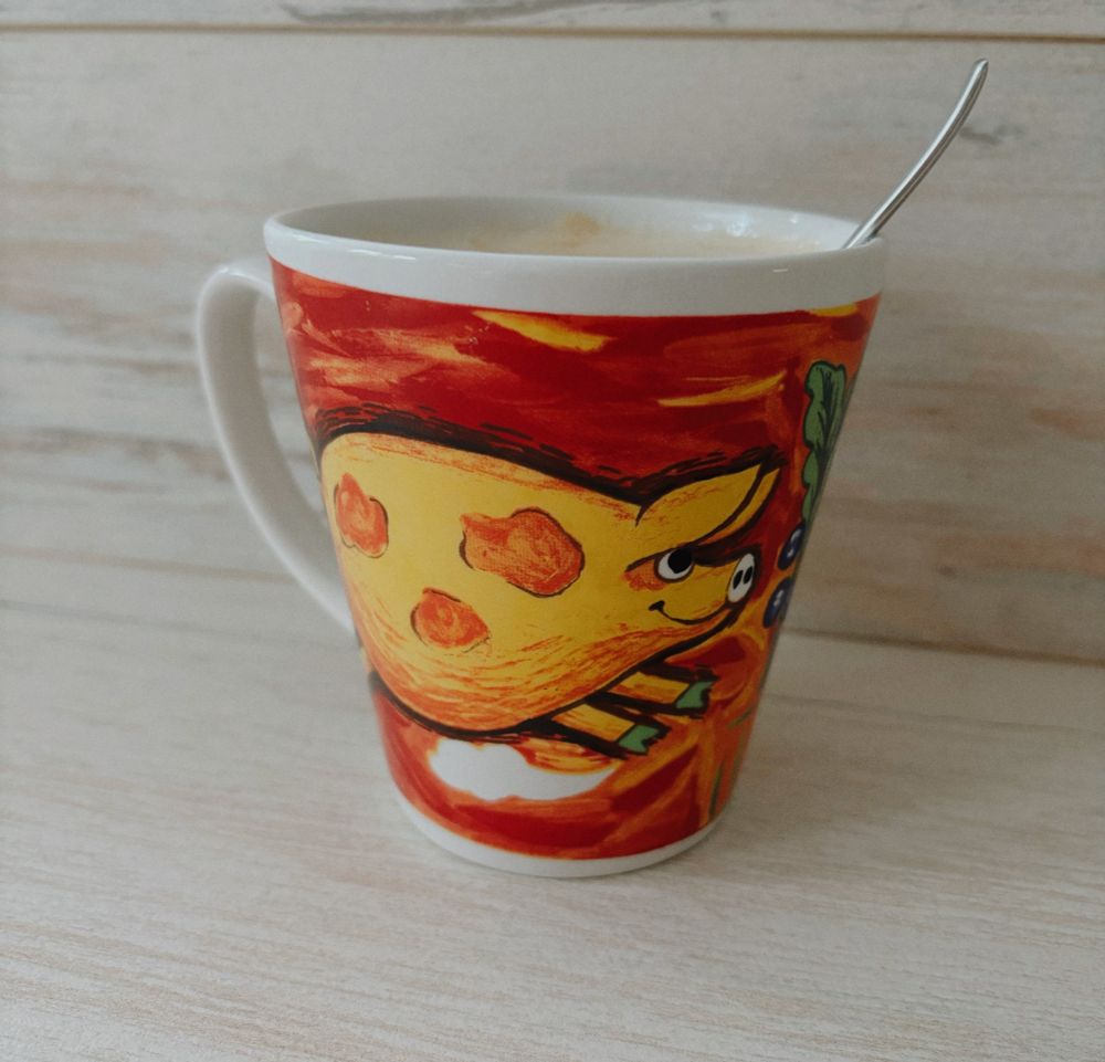 Coffee mug with a yellow pig running.
