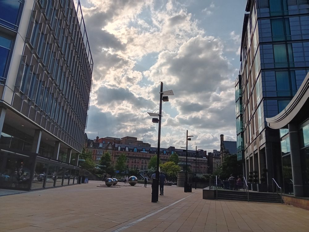 A cloudy summer sky seen between buildings