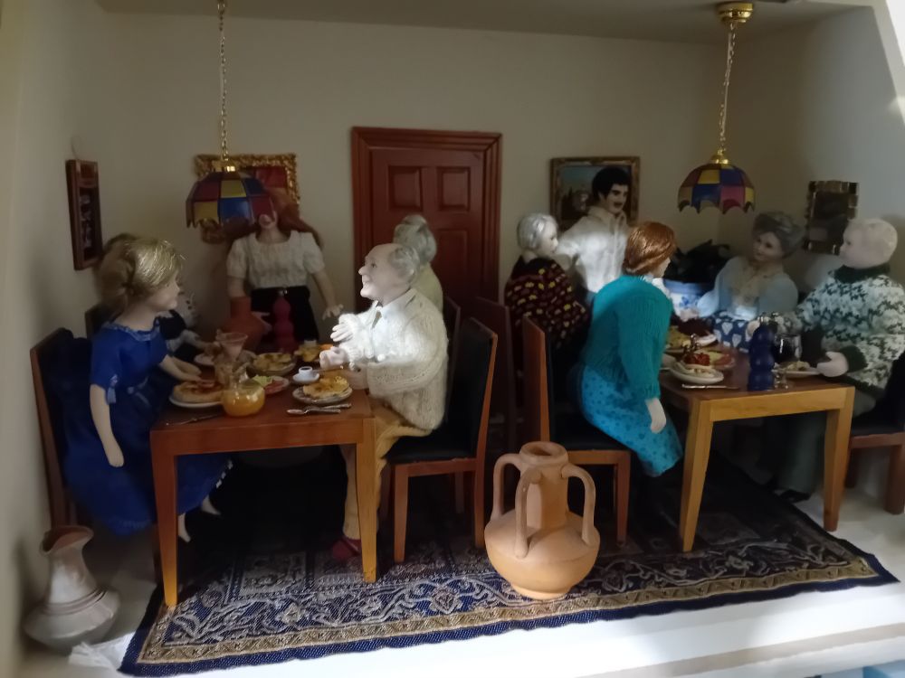 A dollshouse restaurant - upstairs  groups of families and friends have just been served.