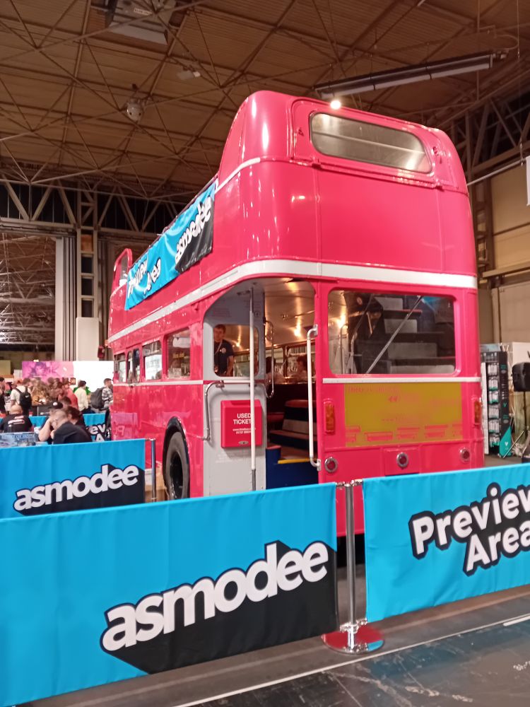 A red bus, promoting Asmodee Games.