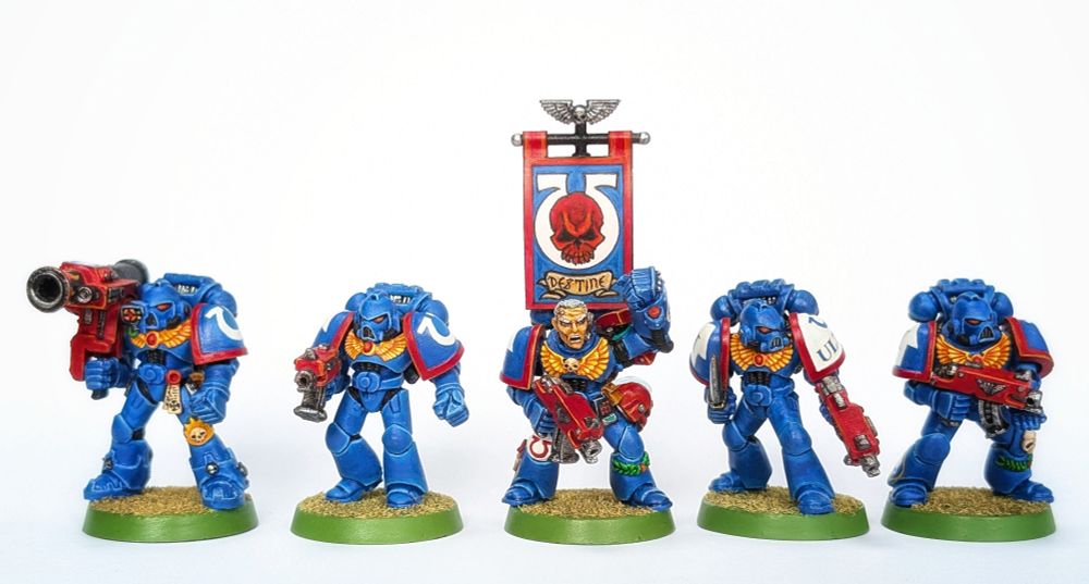 A 5 man squad of 2nd ed Ultramarines. Painted in III Company red trim.