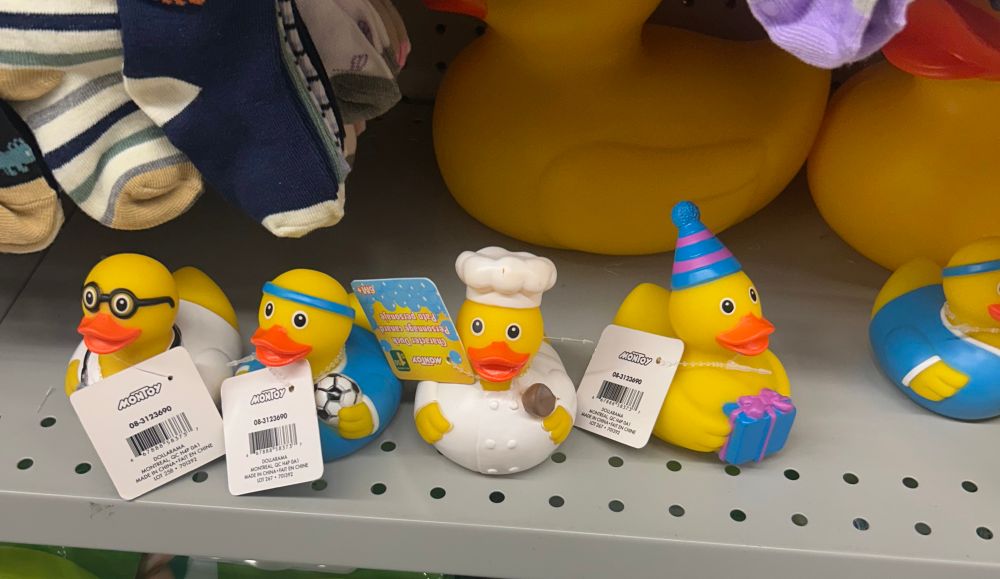 4 rubber duckies dressed like a doctor, a soccer player, a chef and one with a party hat and gift 